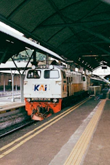 a train pulling into a train station next to a platform