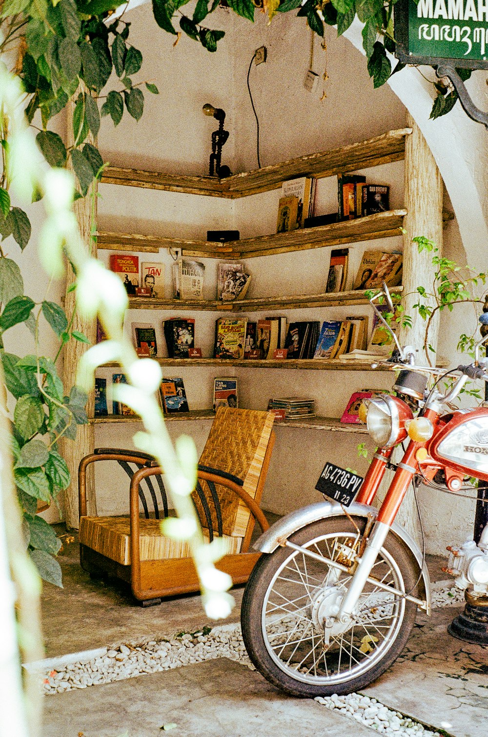 a motorcycle is parked in a room with a book shelf