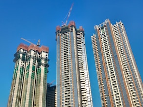 a couple of tall buildings sitting next to each other