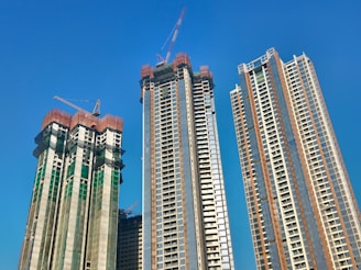 a couple of tall buildings sitting next to each other