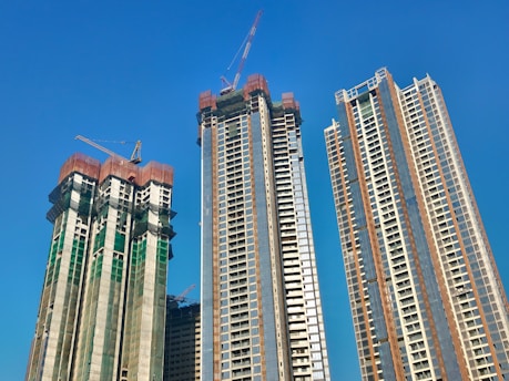 a couple of tall buildings sitting next to each other
