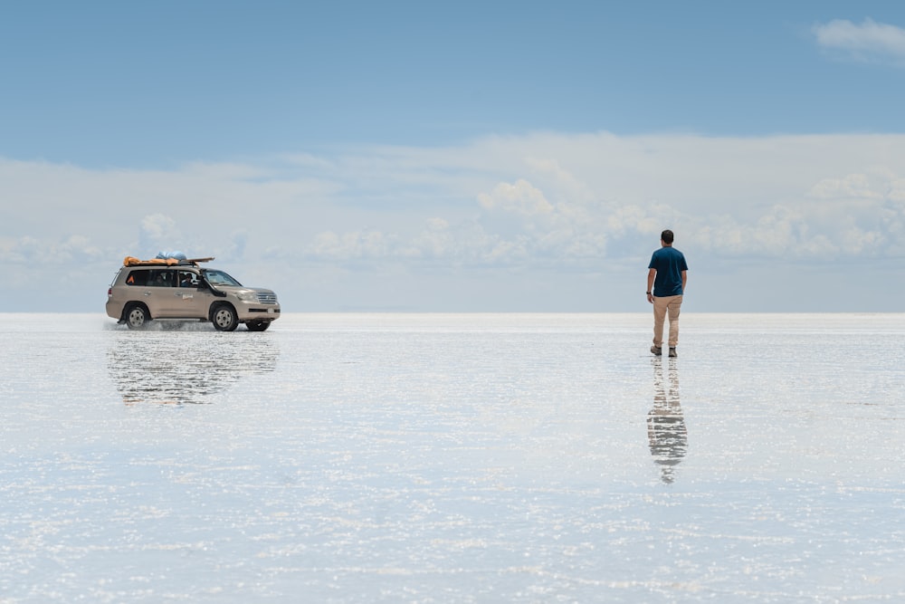 a man standing in the middle of a large body of water