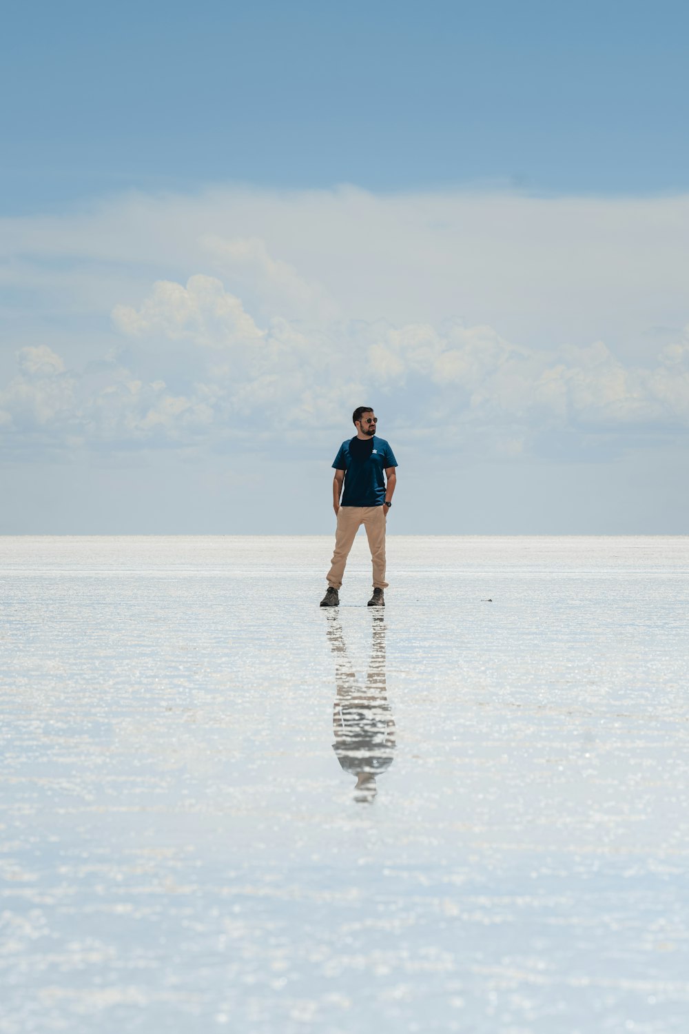 a man standing in the middle of a large body of water