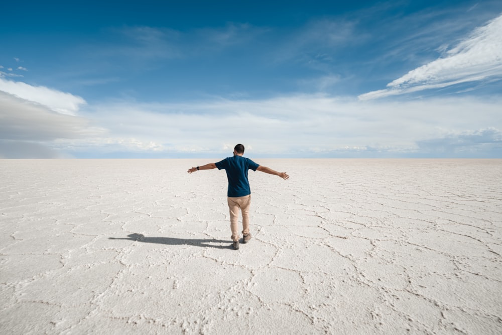 a man standing in the middle of a desert