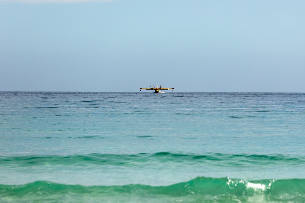 a small boat floating on top of a large body of water