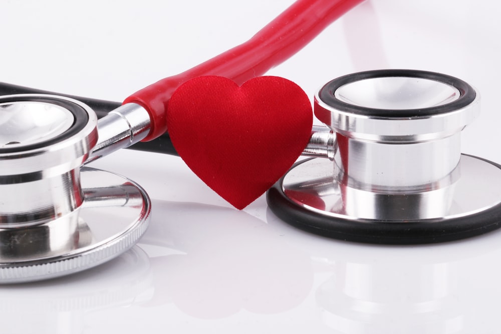 a stethoscope with a red heart on top of it