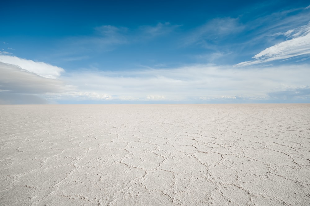 a vast expanse of white sand under a blue sky