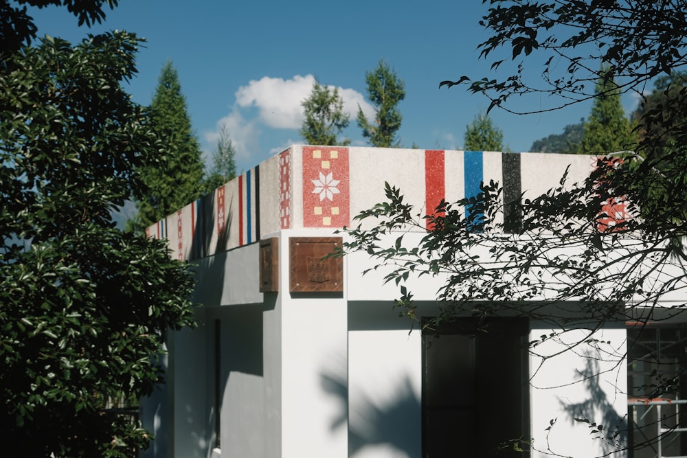 a white building with a red, white, and blue flag on top of it