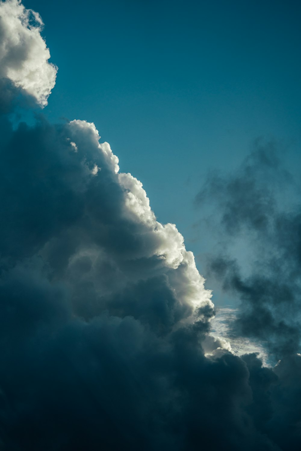 a plane flying in the sky with a lot of clouds