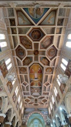 the ceiling of a church with paintings on it