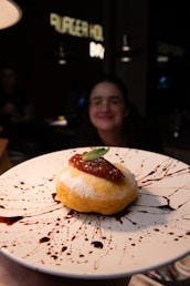 a person holding a plate with a pastry on it