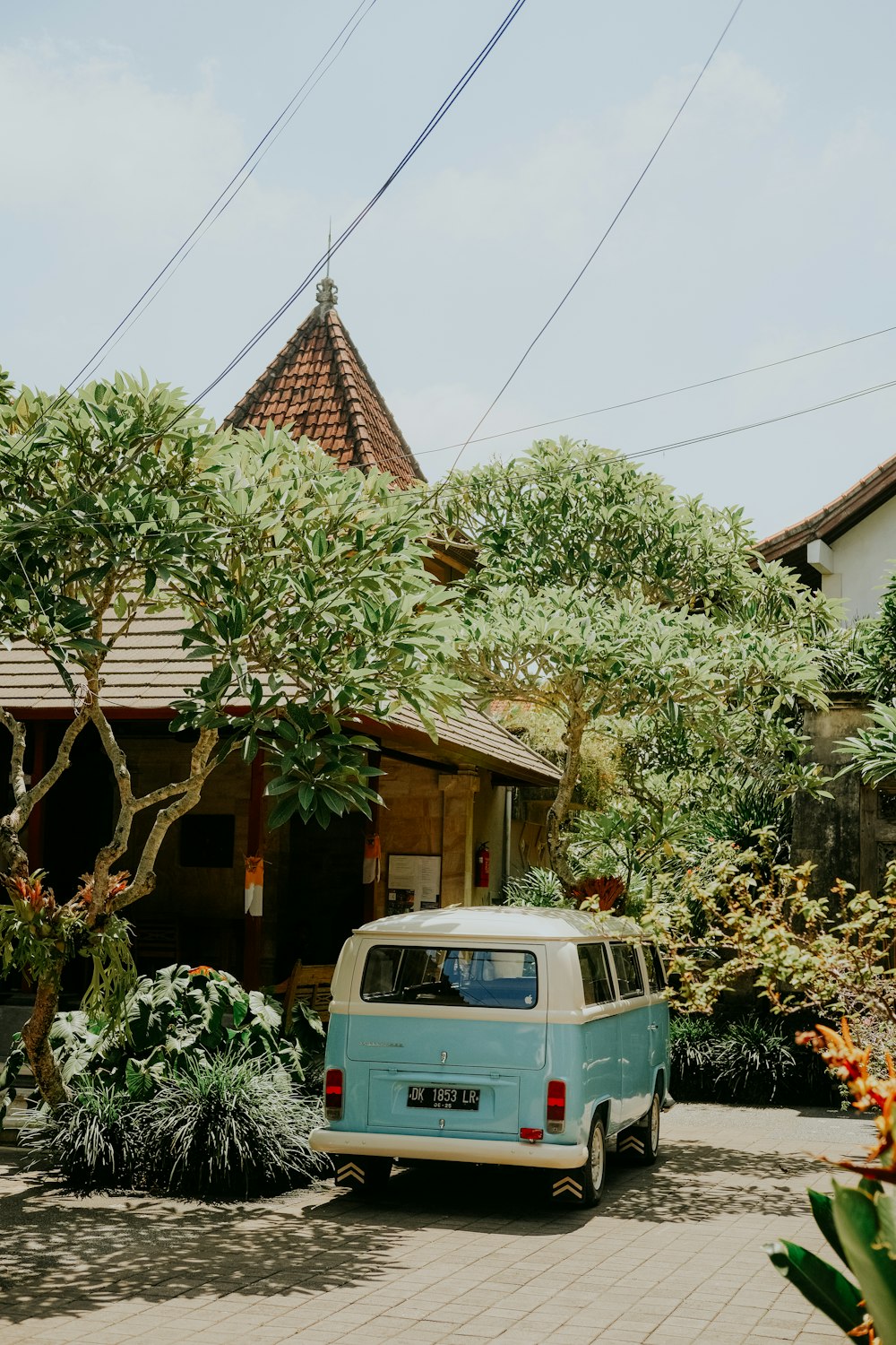 a blue van parked in front of a house