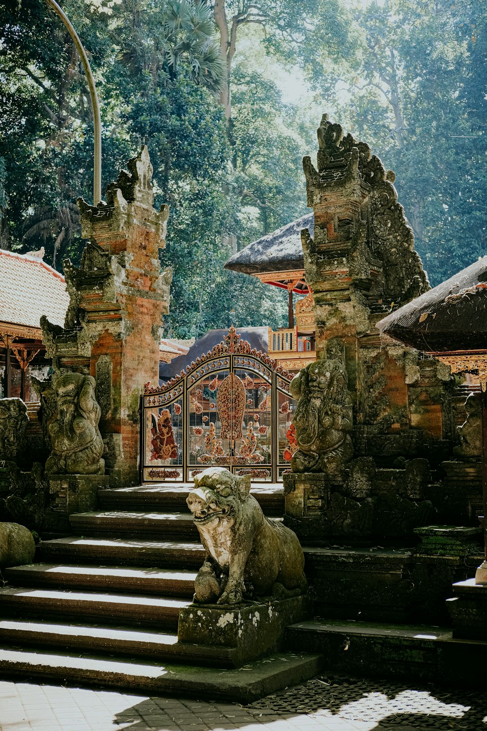 a stone statue sitting on top of a set of steps