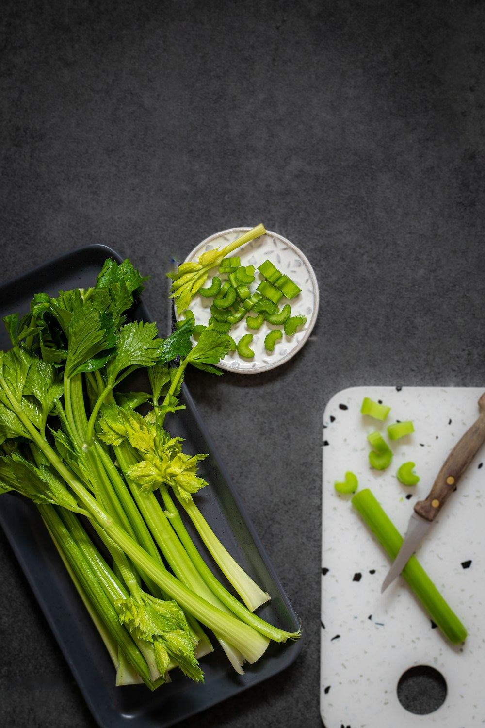 a cutting board with celery and a knife on it
