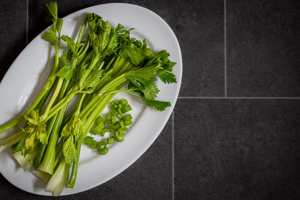 a white plate topped with green leafy vegetables