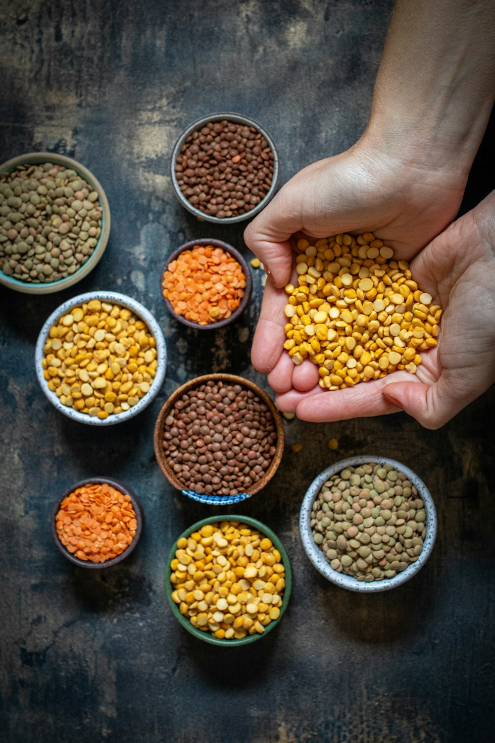 a person holding a handful of food in their hands