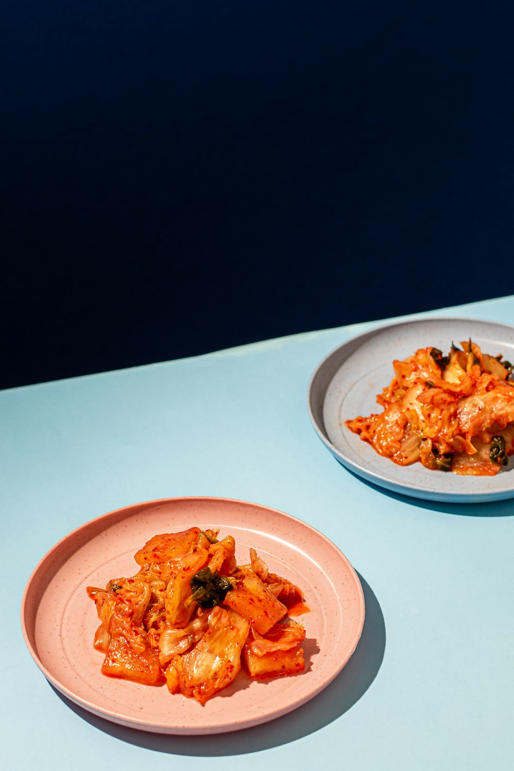 two plates of food sitting on a table