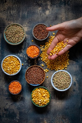 a person reaching for some food in small bowls