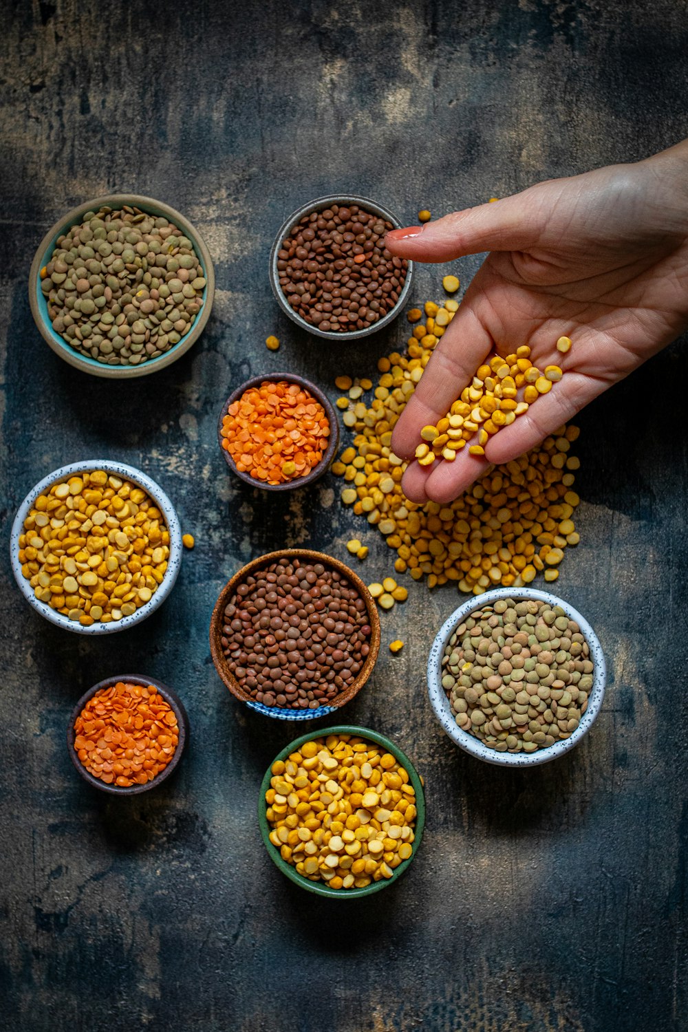 a person reaching for some food in small bowls