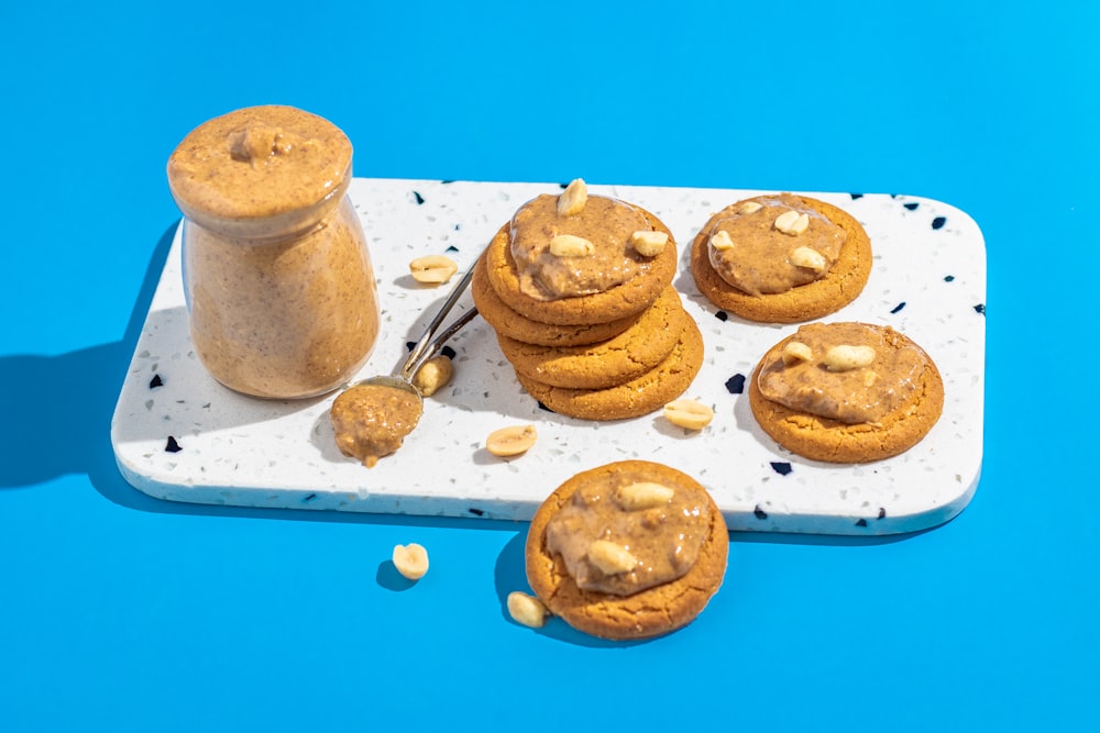 a tray of cookies and a jar of peanut butter