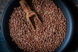 a pan filled with beans and a wooden spoon