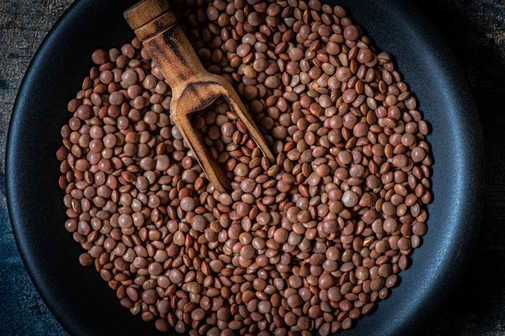 a pan filled with beans and a wooden spoon
