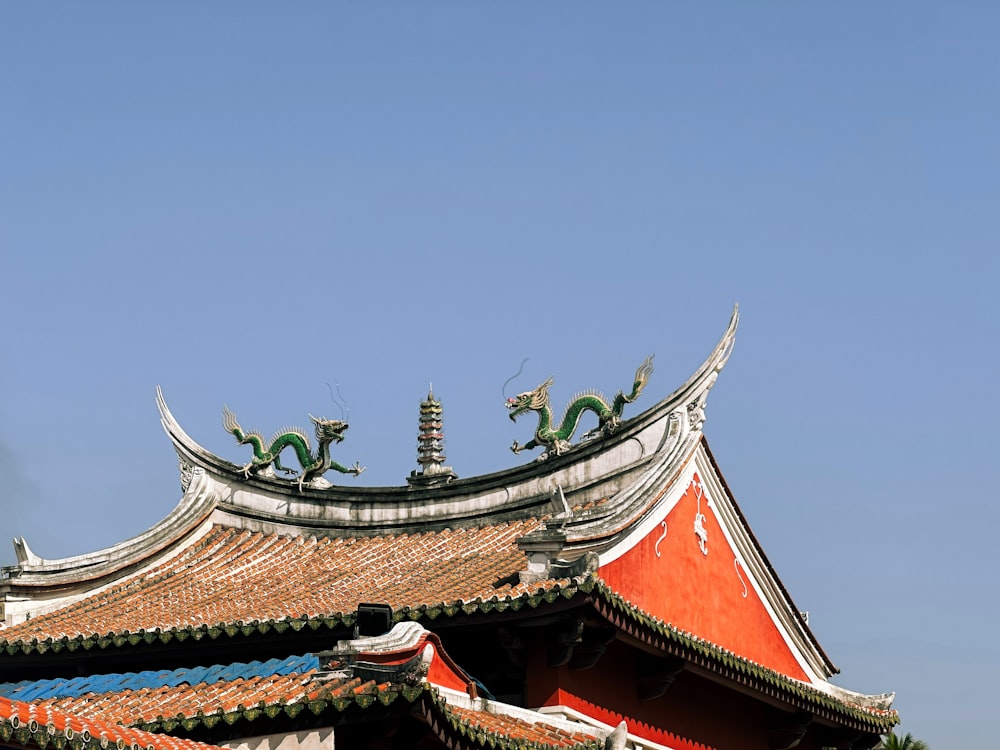 the roof of a building with a dragon decoration on top