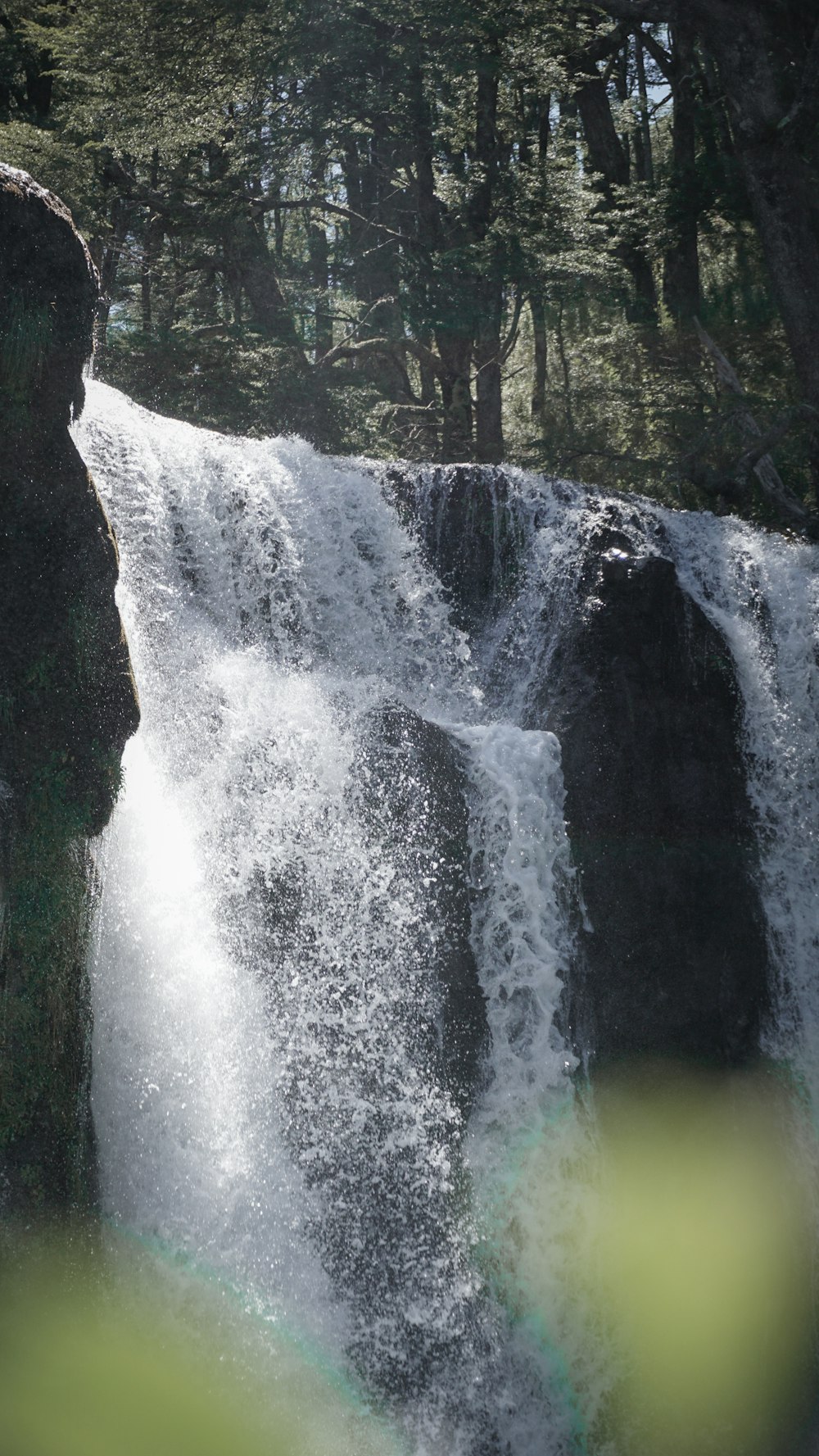 a man standing in front of a waterfall