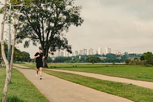a man running down a path in a park
