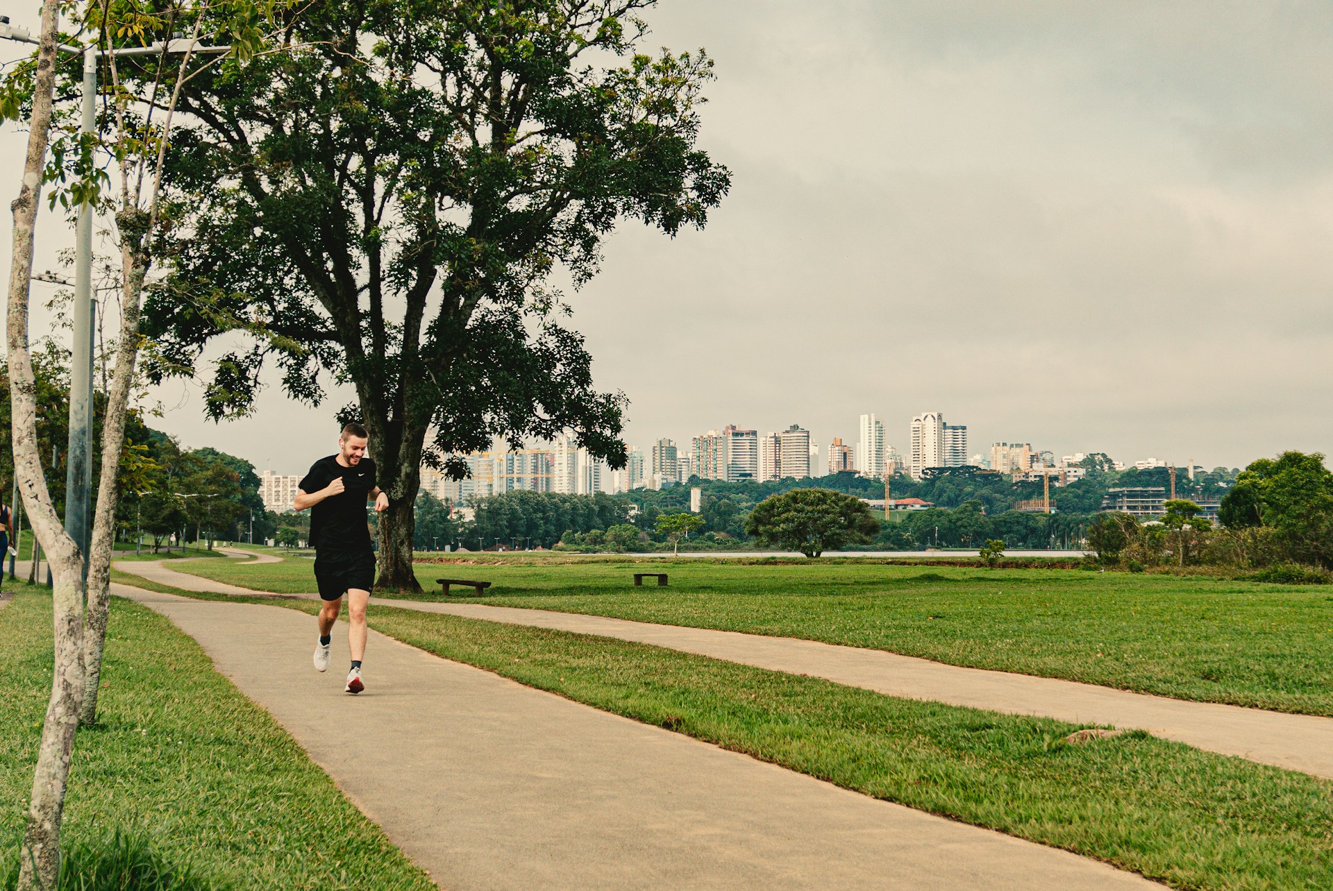a man running down a path in a park