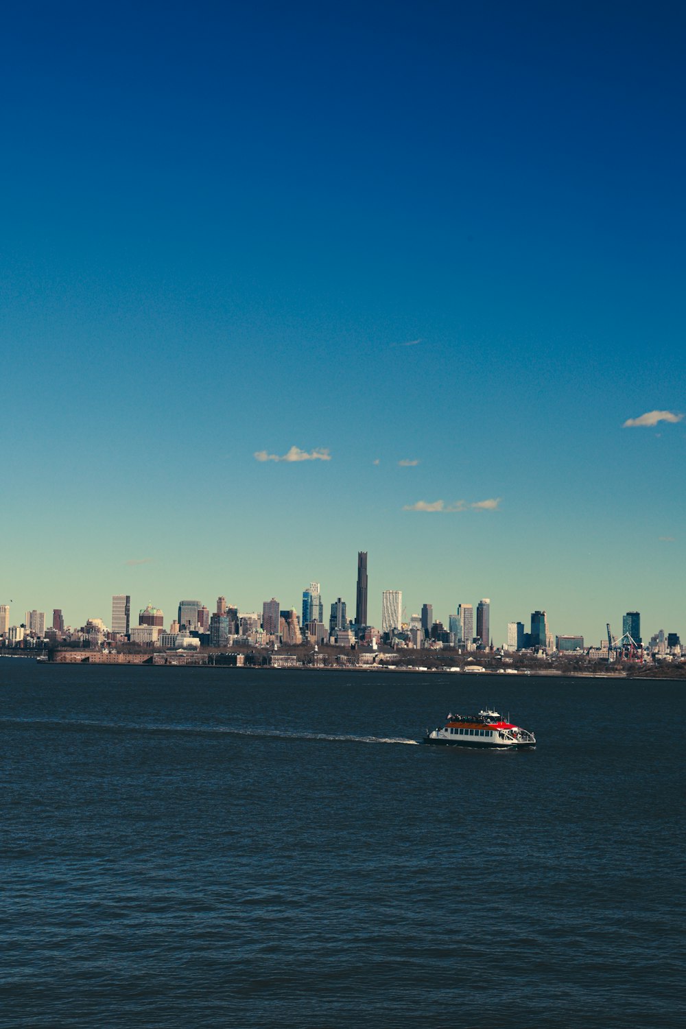 a boat in the water with a city in the background