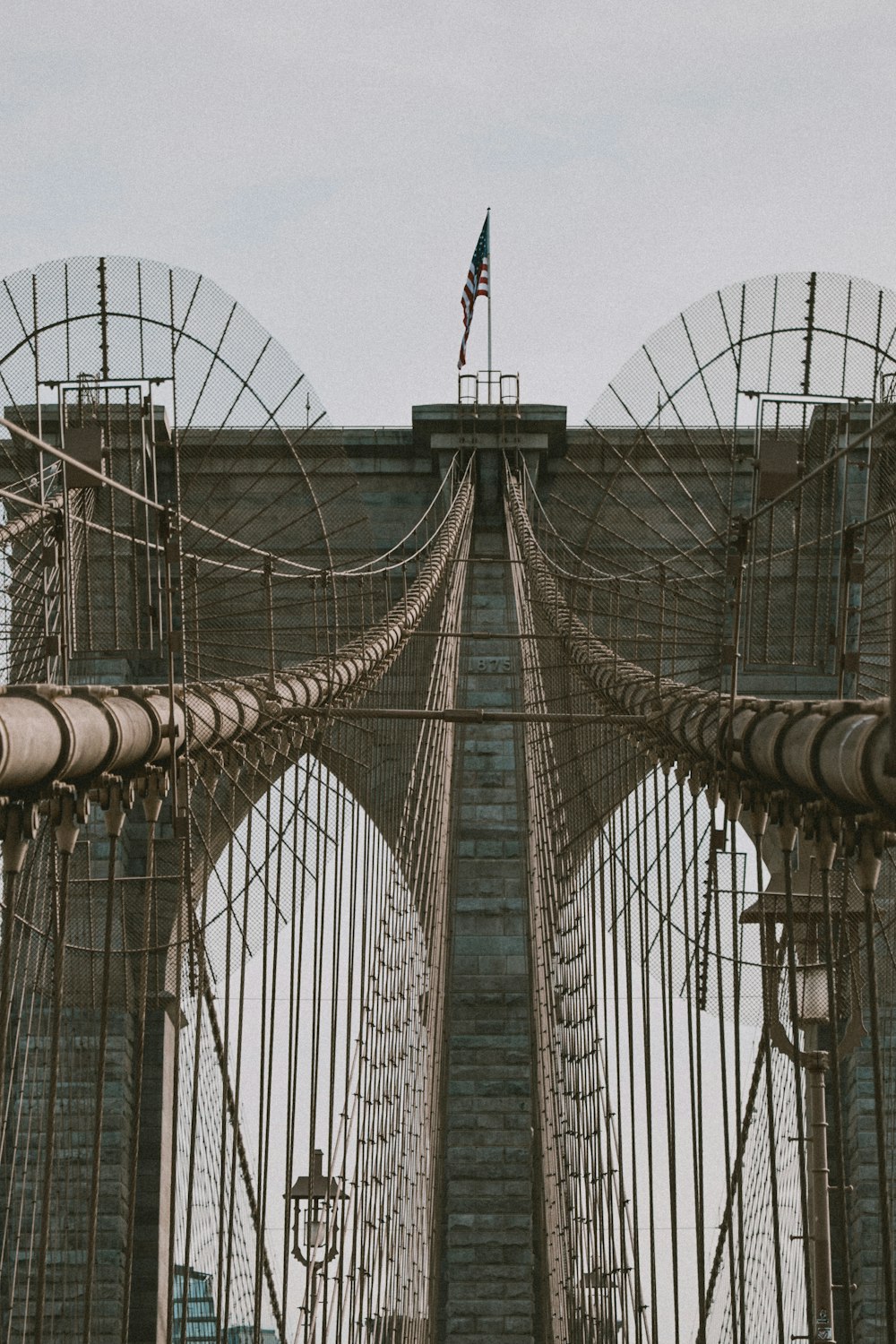 a tall bridge with a flag on top of it