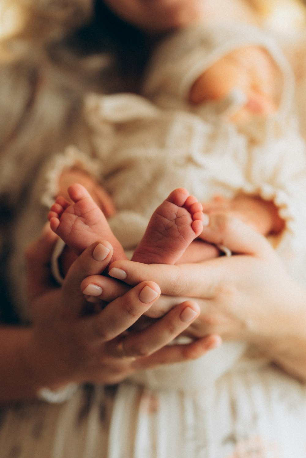 a close up of a person holding a baby