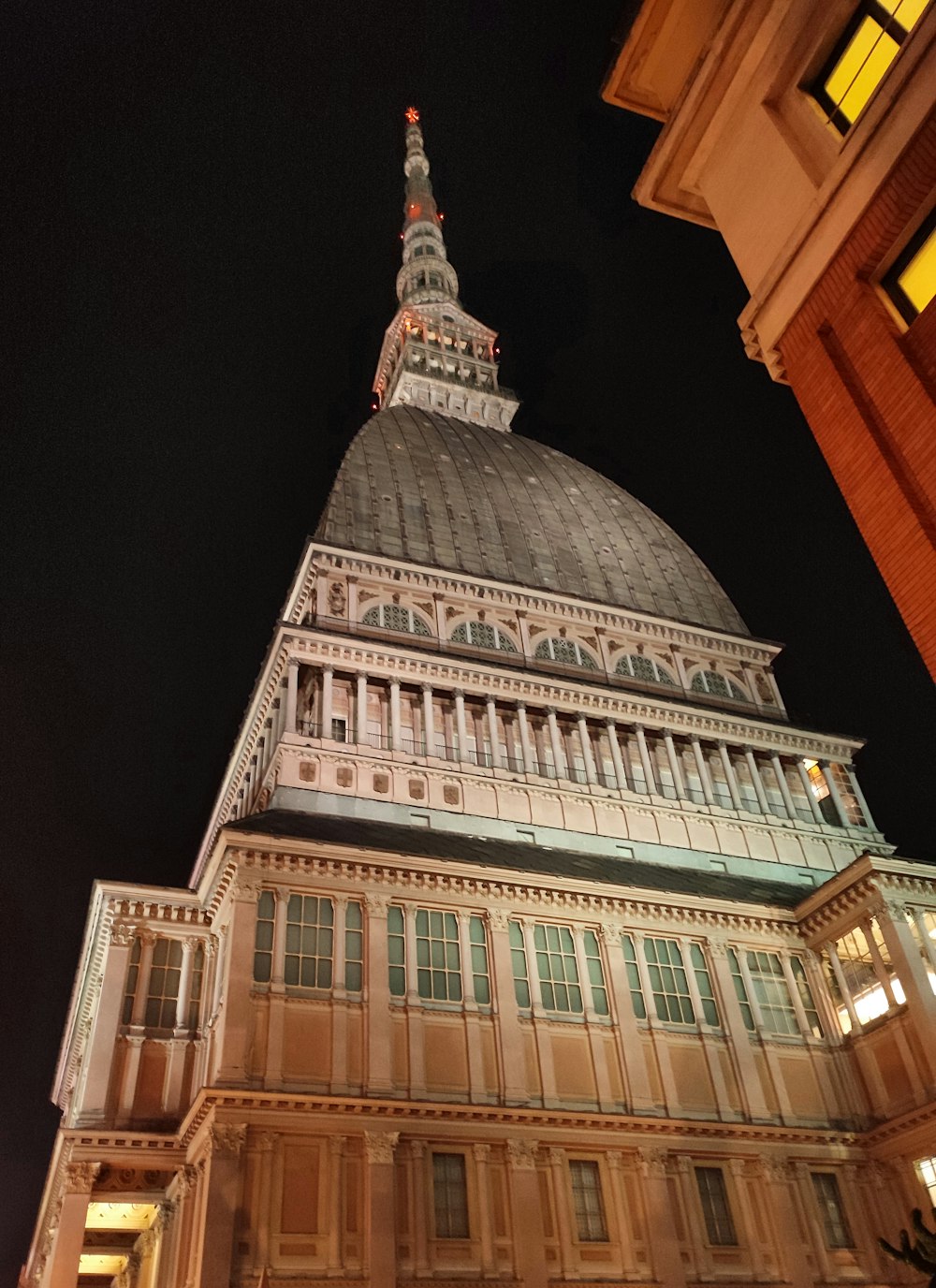 a tall building with a steeple at night