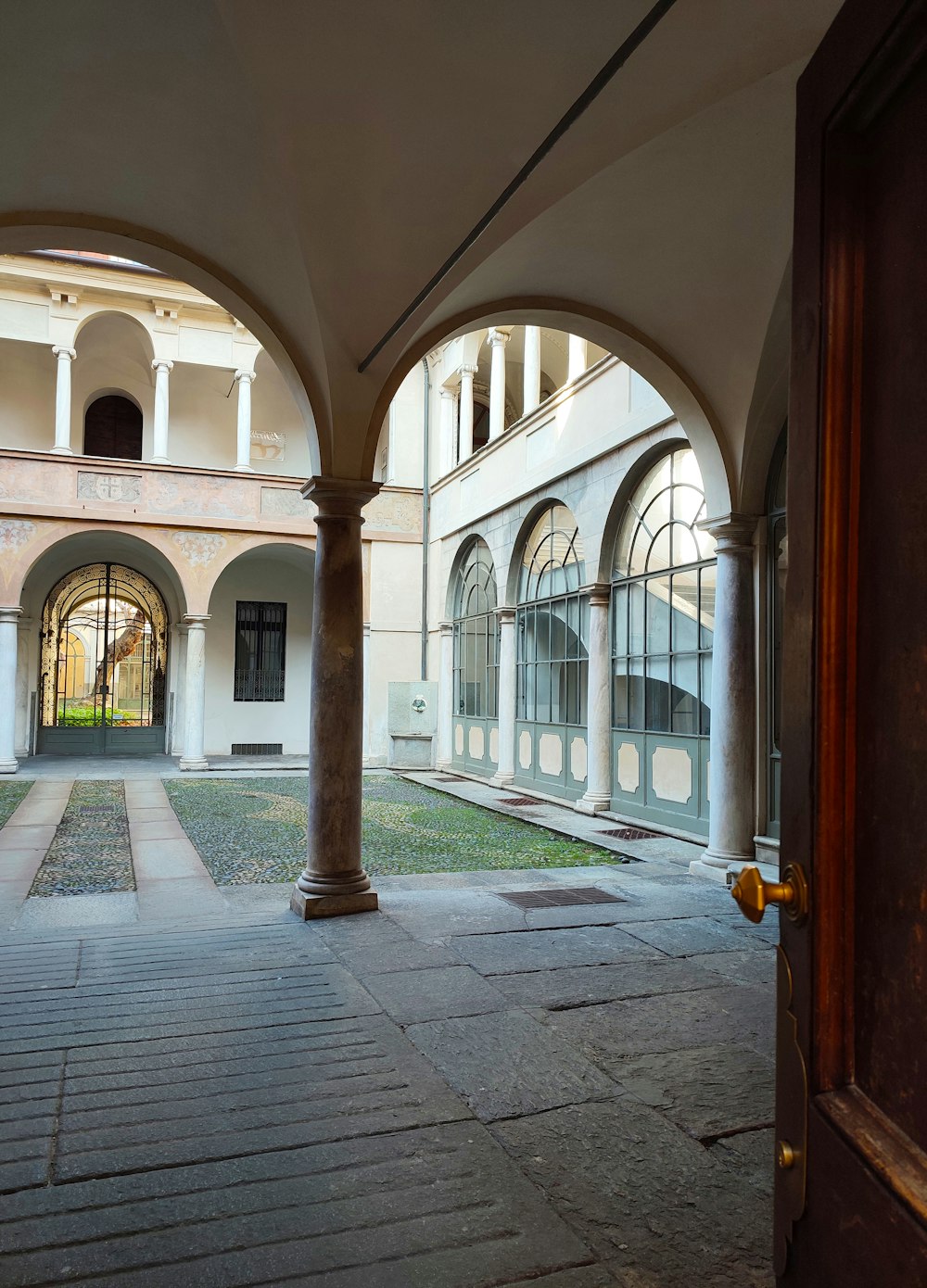 a building with arches and a clock on the wall