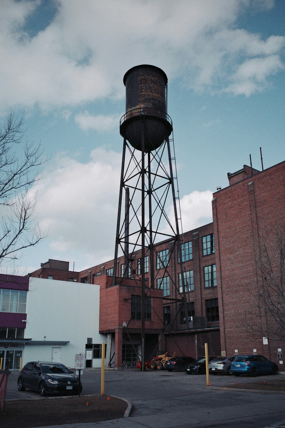 a water tower in front of a brick building