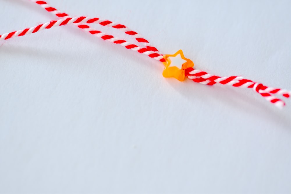 a red and white string with a star on it
