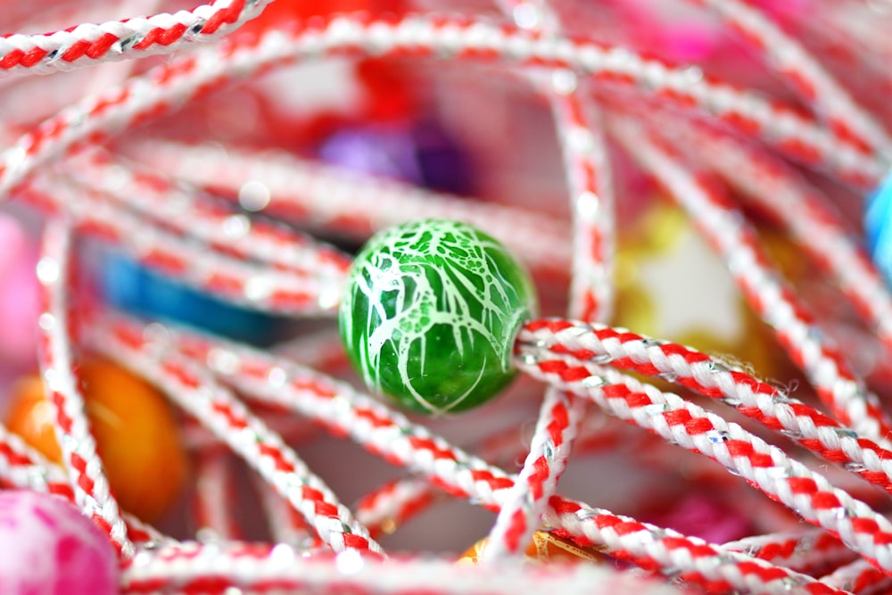 a close up of a green ball on a string