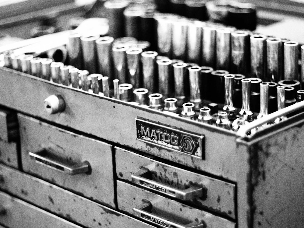 a metal tool box filled with lots of screws