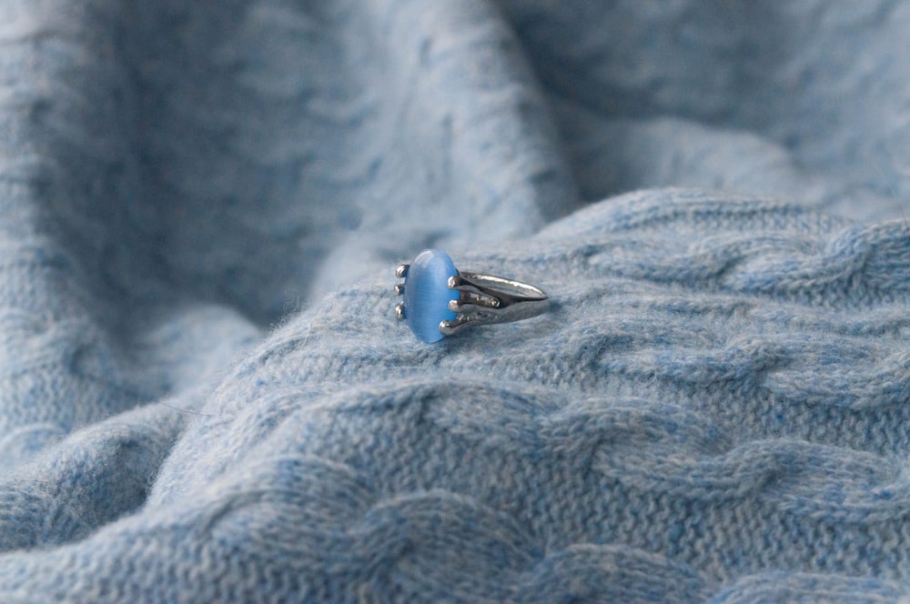 a blue ring sitting on top of a blue blanket