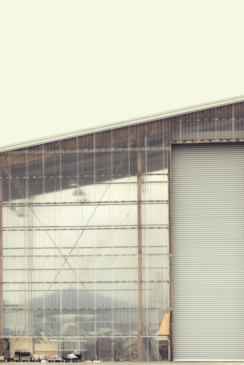 an airplane is parked in front of a hangar