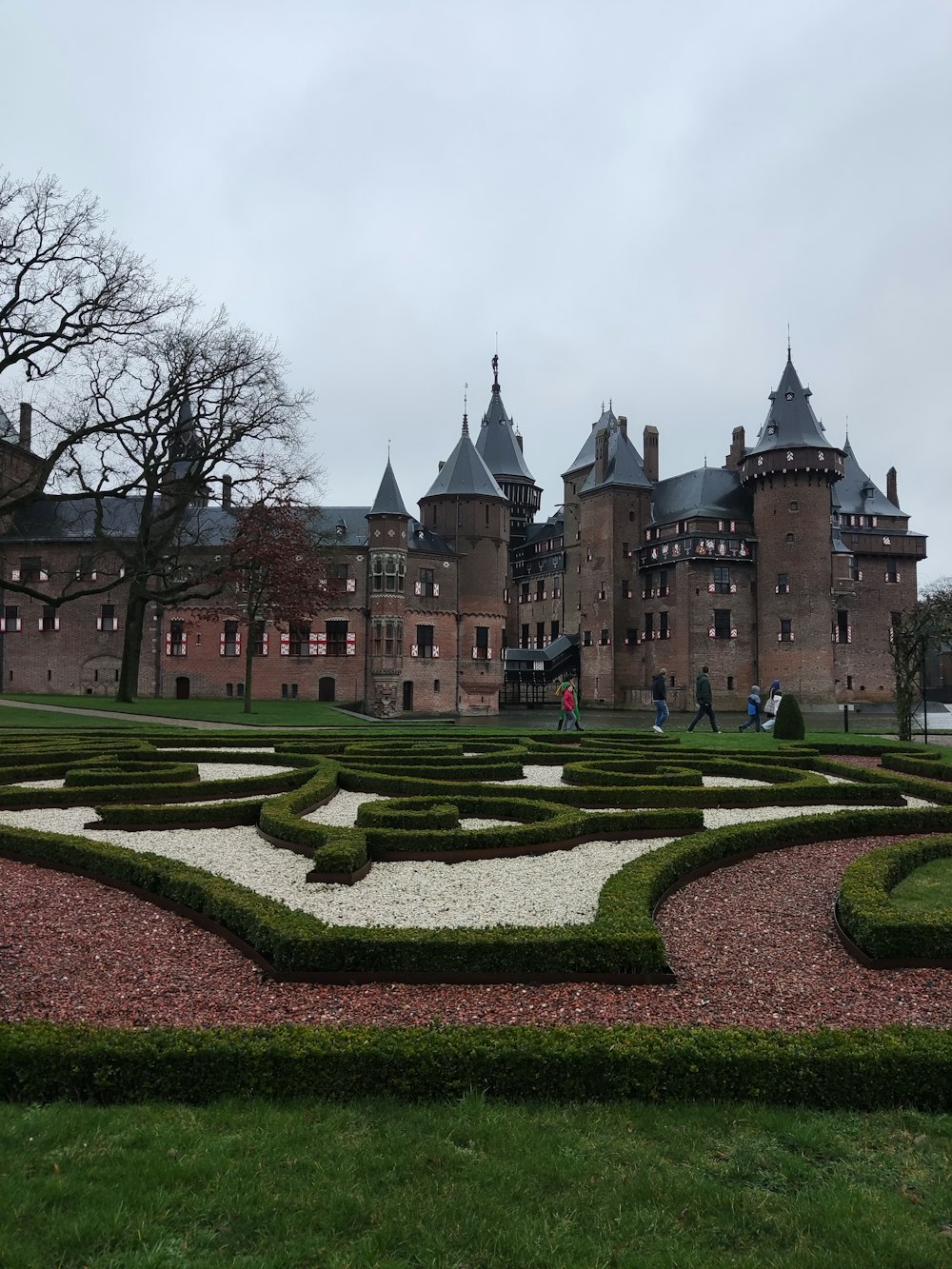 a large building with a large garden in front of it