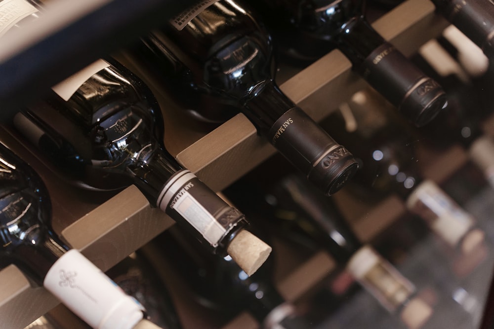 a bunch of bottles of wine sitting on a shelf