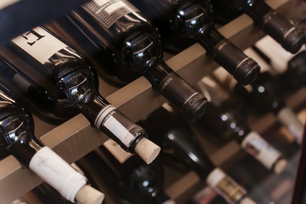 a bunch of bottles of wine sitting on a shelf