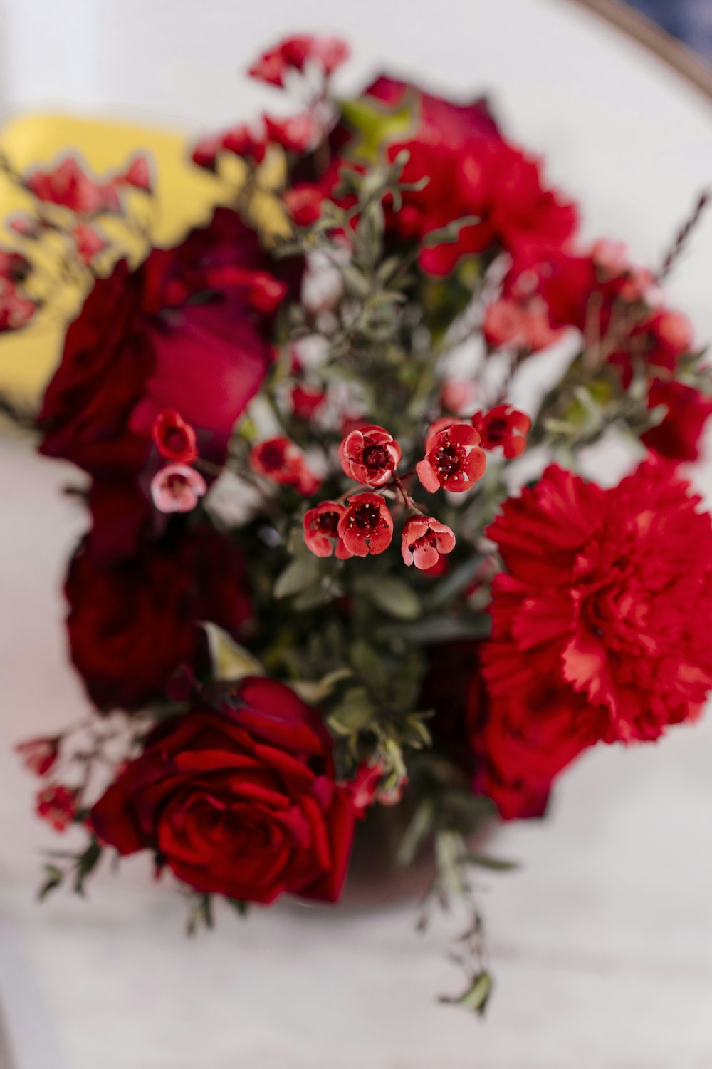 a bouquet of red flowers sitting on top of a table