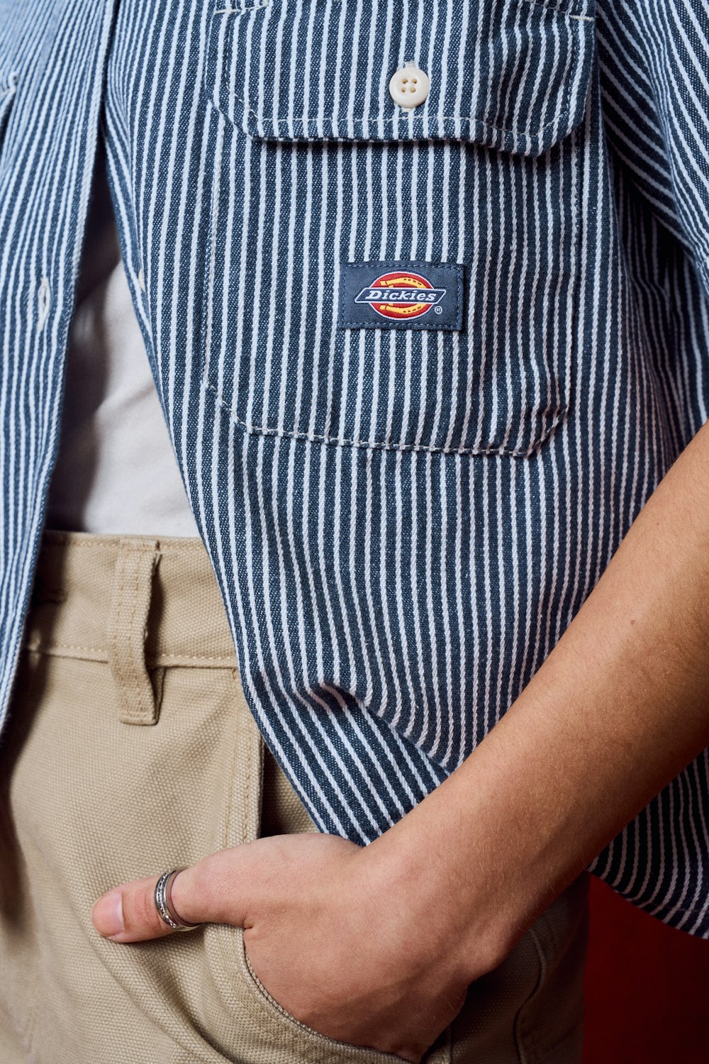 a close up of a person wearing a button down shirt