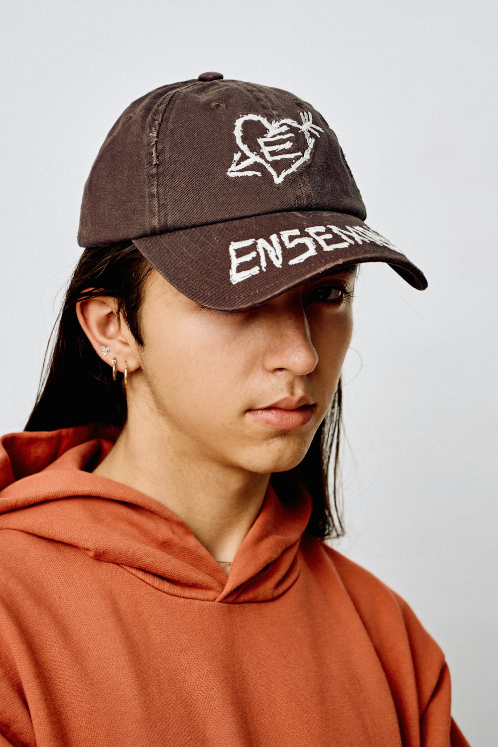 a woman wearing a brown hat with white writing on it