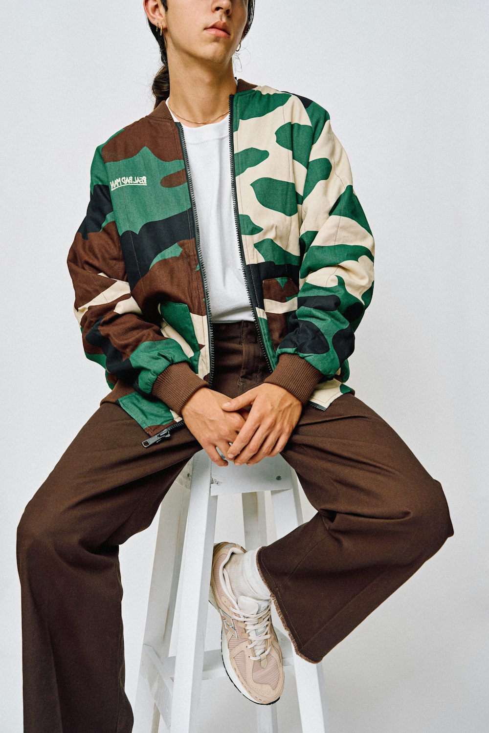 a man sitting on top of a white stool