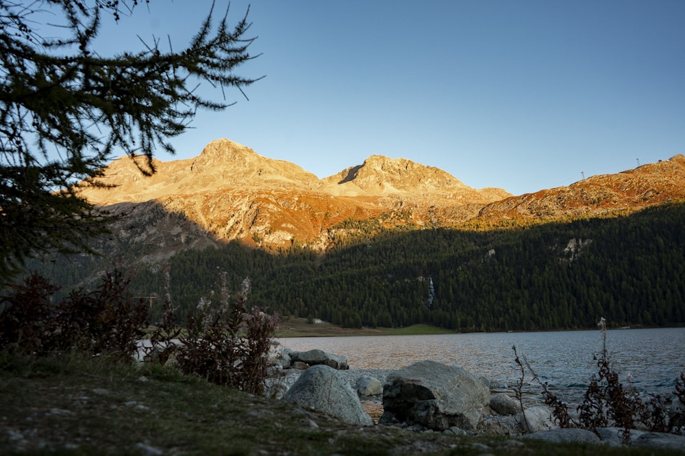 a view of a mountain range with a lake in the foreground