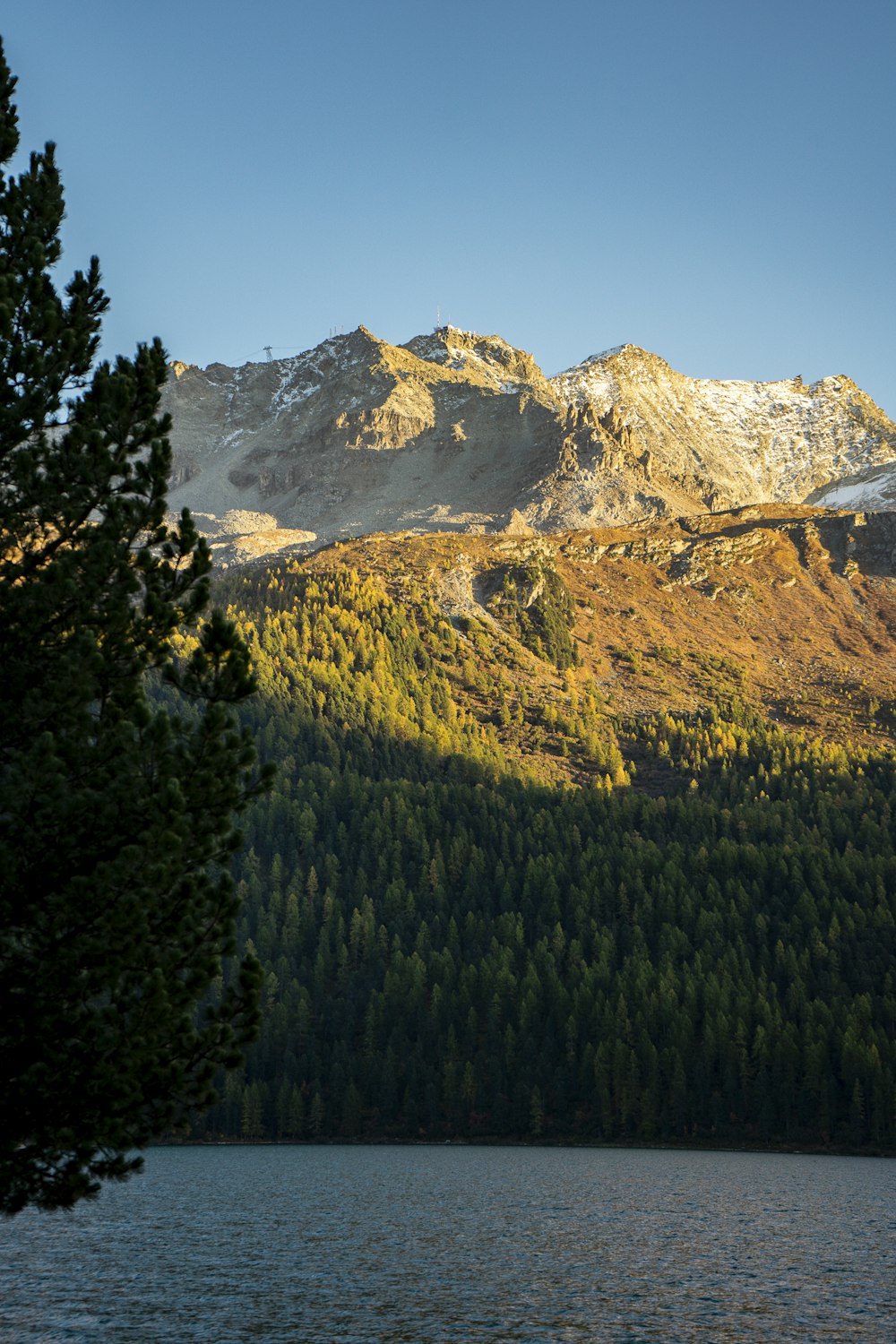 a mountain range with a lake in the foreground